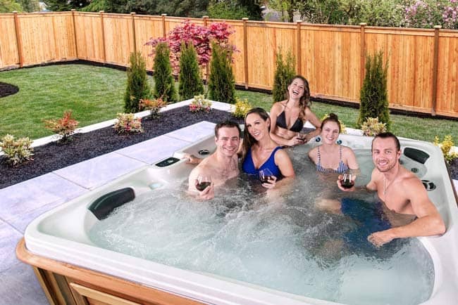 Friends drinking in the hot tub
