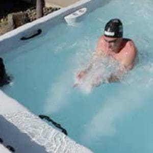 Man swimming in a swim spa