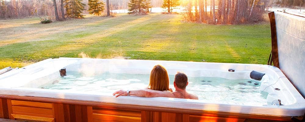 Couple looking at the sunset in the swim spa